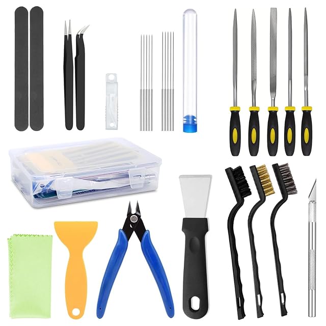 Tool set laid out: sanding sticks, tweezers, needles in a tube, five files, a clear box, cloth, plastic and steel scrapers, flush cutter, brushes and a hobby knife