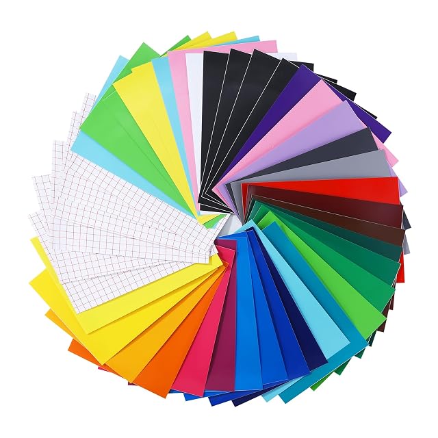 Coloured vinyl sheets fanned in a circle with several white sheets printed with a red grid