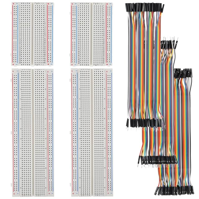Two 400-point and two 830-point breadboards beside three rainbow jumper ribbons