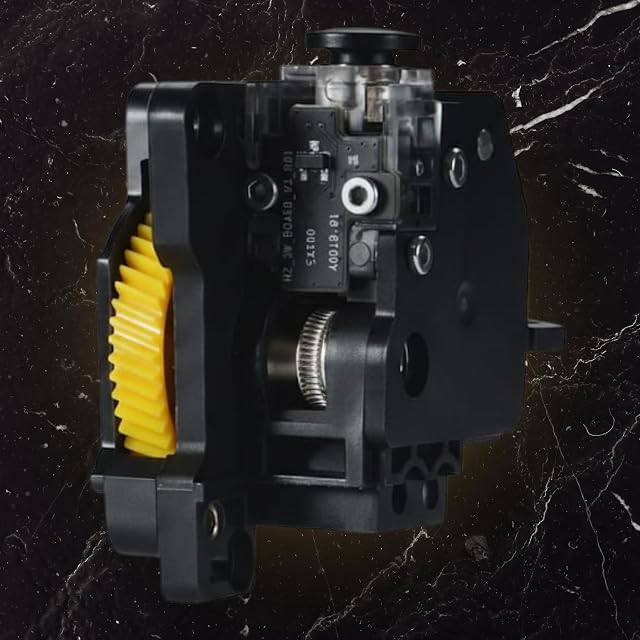 Black extruder unit with a yellow gear, a knurled drive gear, a small circuit board and a black knob