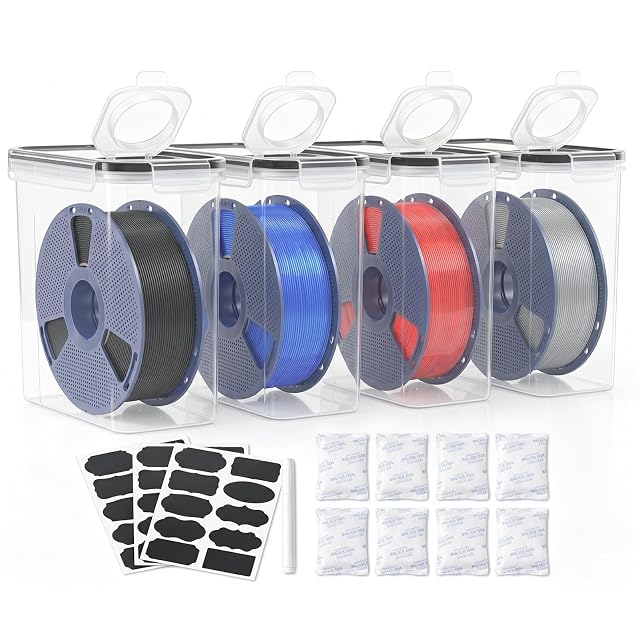 Four tall transparent boxes with flip-up lids holding spools, three sheets of black labels, a white marker and eight silica gel packs