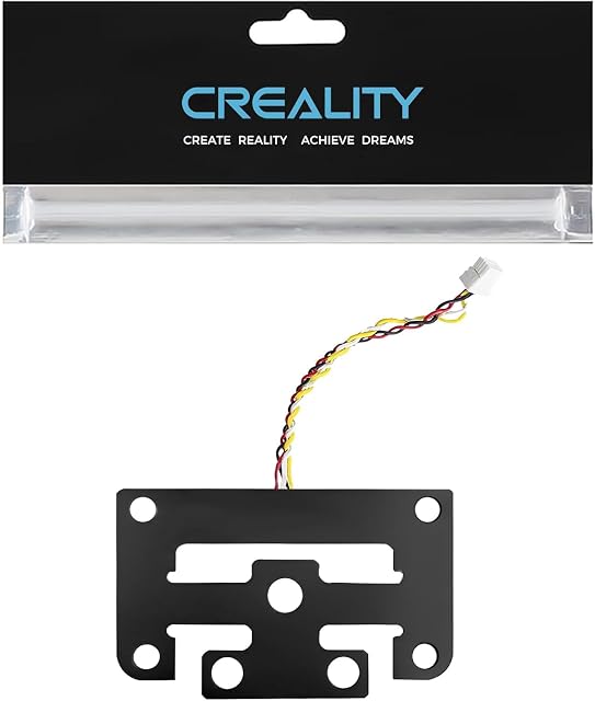 Black strain gauge plate with screw holes and a plugged four-wire cable, below a Creality package header
