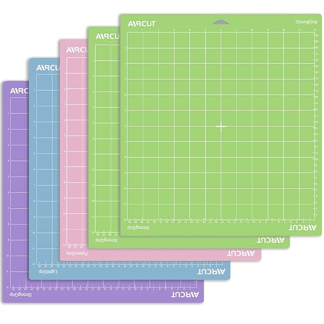 Five AIRCUT gridded mats fanned out in purple, blue, pink and two greens, labels reading StrongGrip, LightGrip and FabricGrip